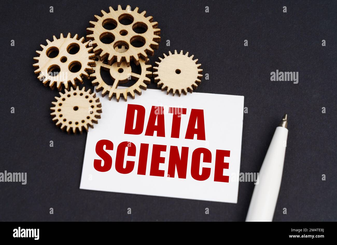 Industrial concept. On the black surface are gears, a pen and a business card with the inscription - DATA SCIENCE Stock Photo