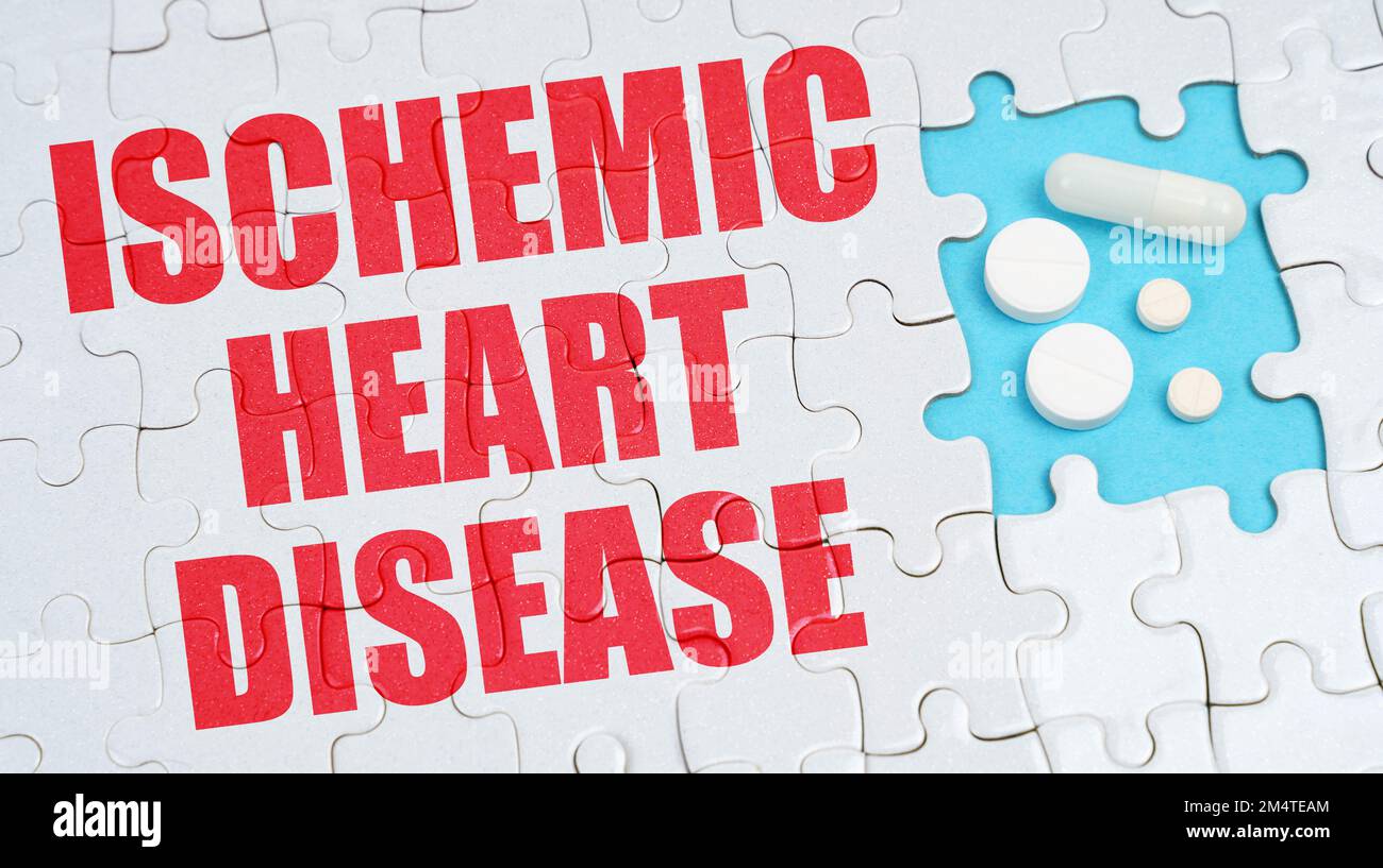 Medical concept. On the puzzles there is an inscription - Ischemic Heart Disease, on a blue background pills. Stock Photo