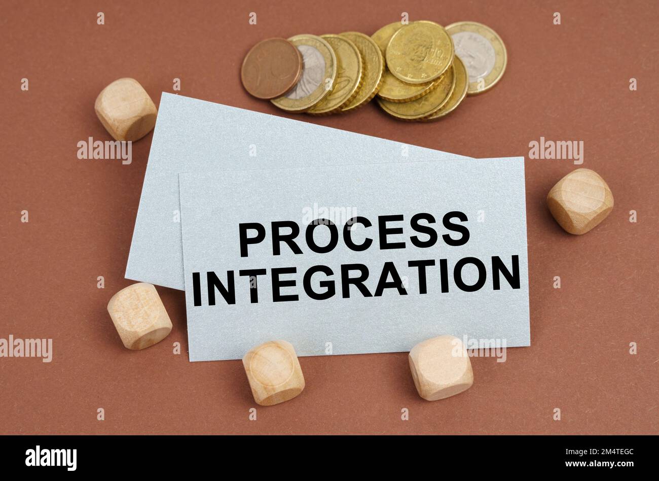 Business and finance concept. On a brown surface are coins, cubes and a ...
