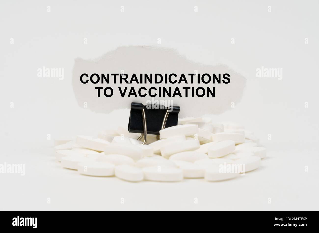 Medical concept. On a white surface are pills and torn paper with the