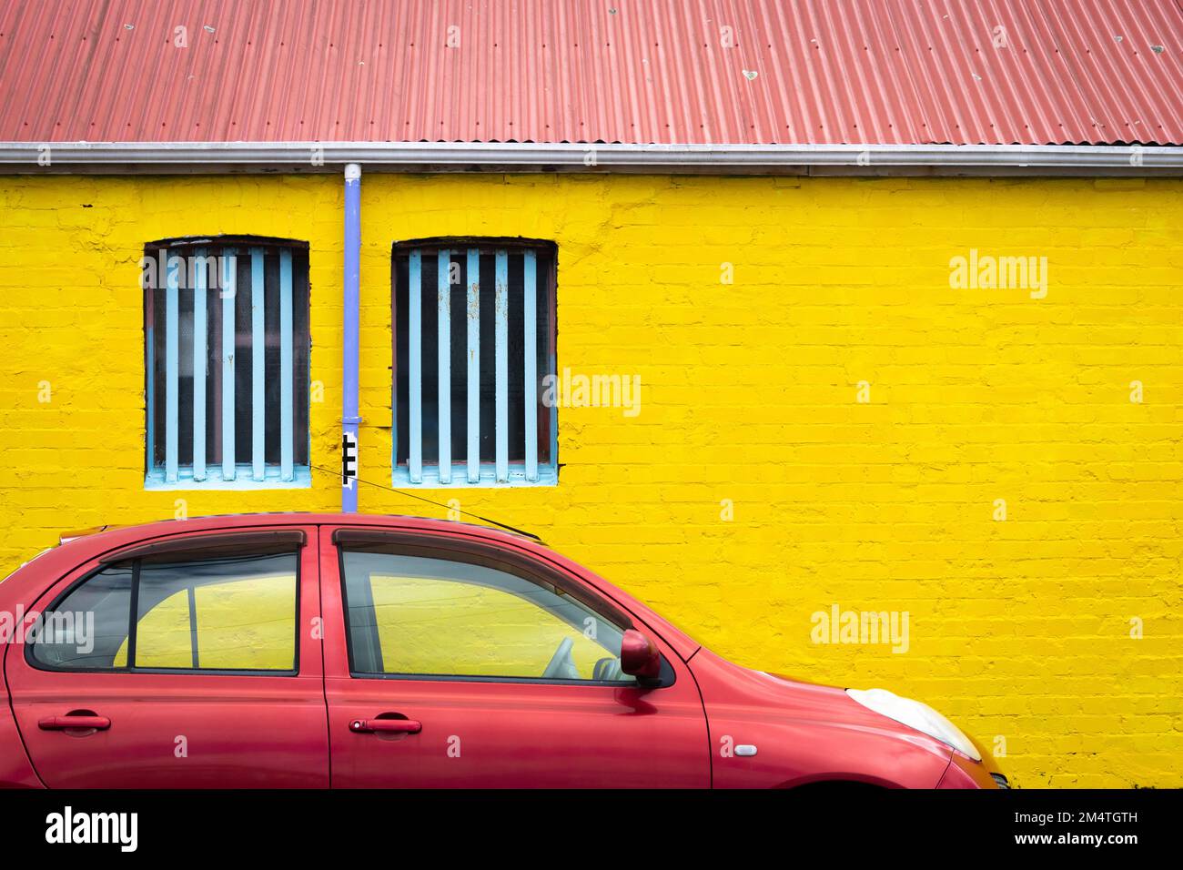 Yellow wall with red car and red roof, Wellington, North Island, New