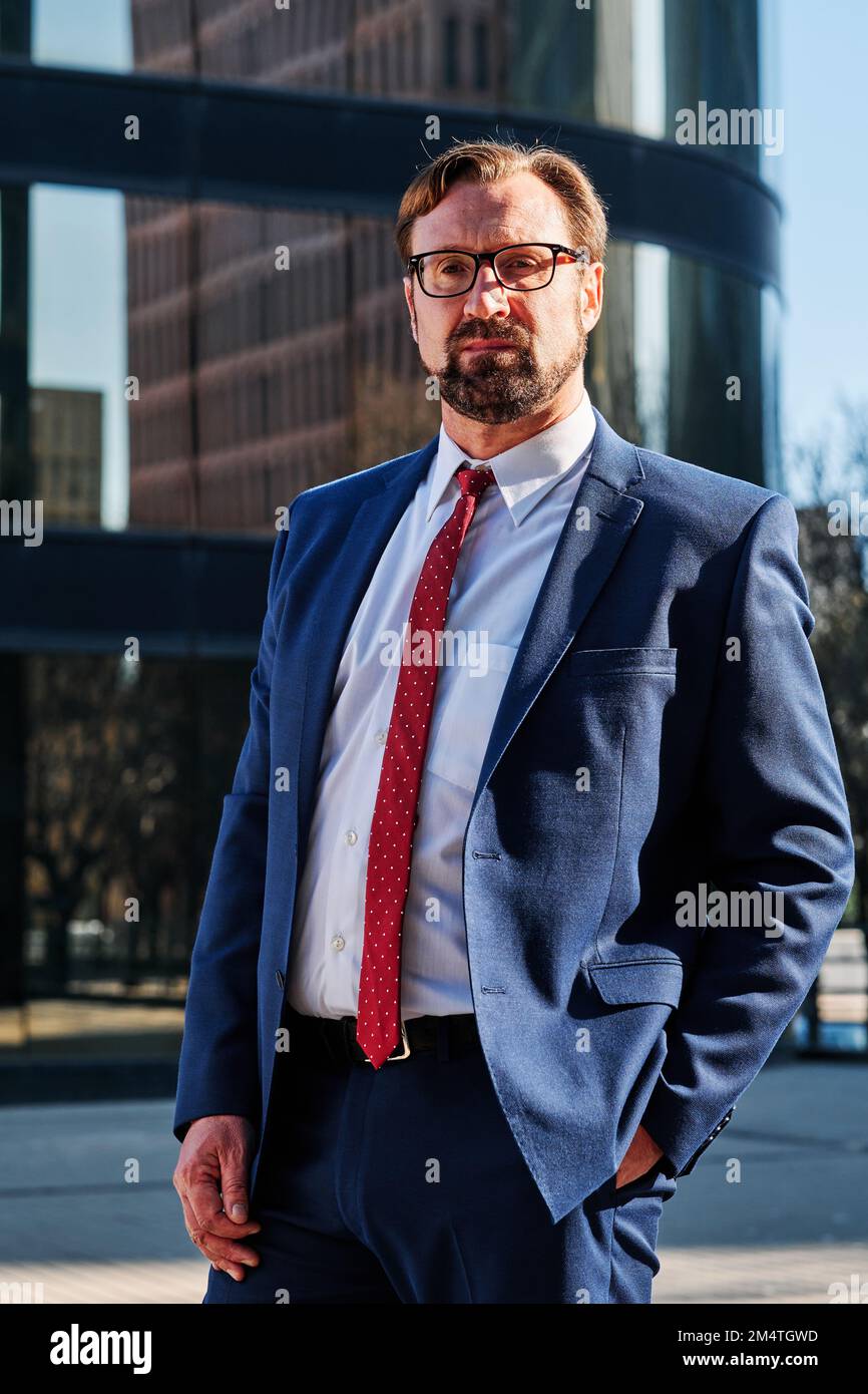 Vertical portrait of a serious businessman in the street Stock Photo