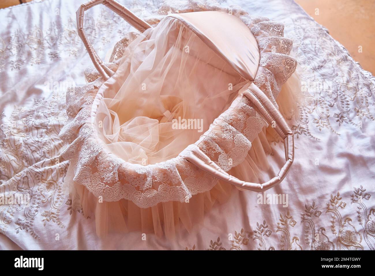 Beautiful carrycot or cradle with lace and ribbons for a newborn baby Stock Photo