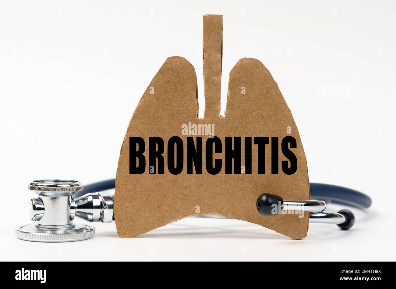 Medical concept. On a white surface are a stethoscope and a cardboard figure of a lung with the inscription - Bronchitis Stock Photo