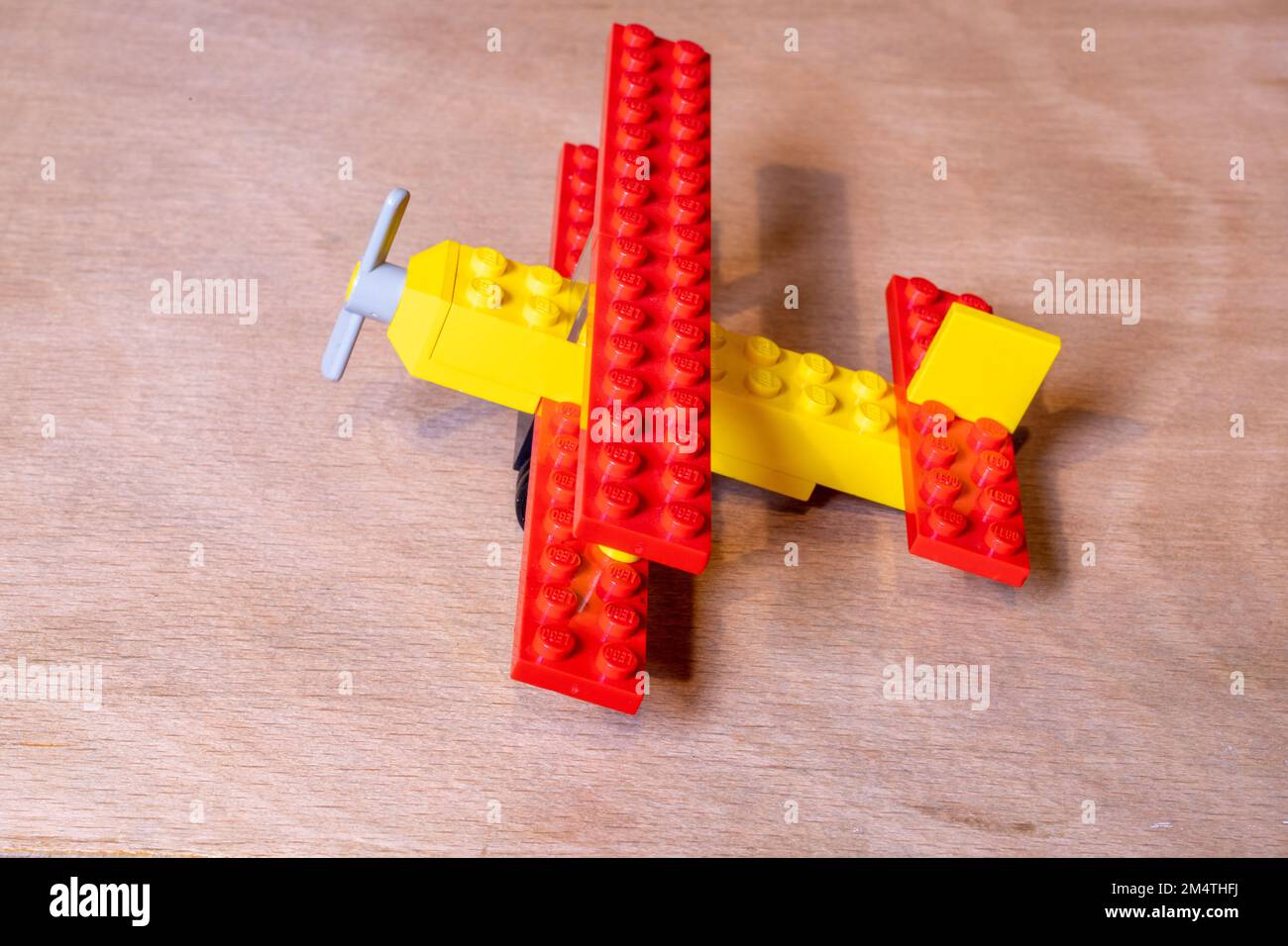 A closeup shot of a lego 613: Biplane set on a wooden surface Stock Photo -  Alamy