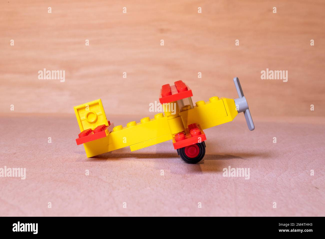 A closeup shot of a lego 613: Biplane set on a wooden surface Stock Photo -  Alamy