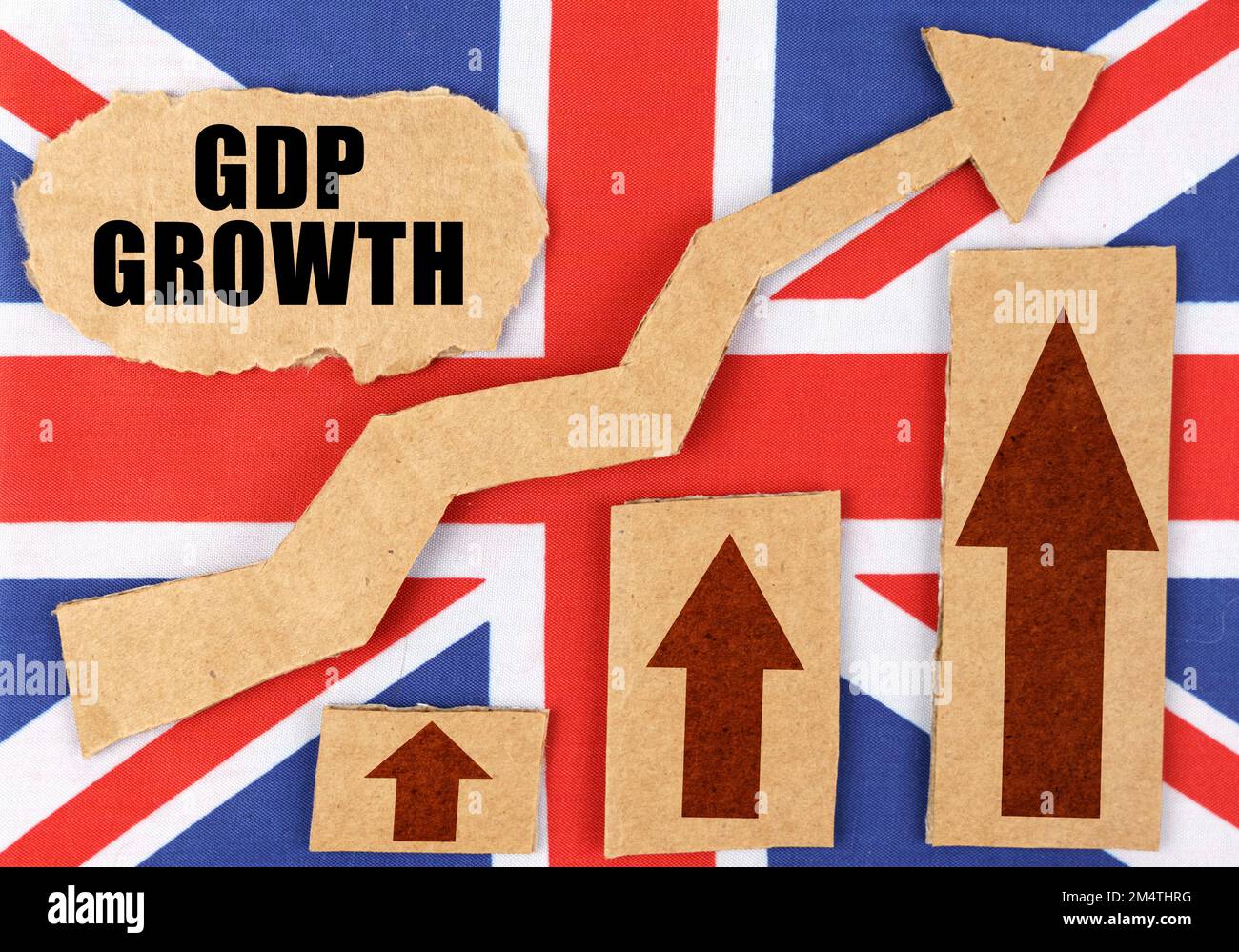 The concept of national statistics. On the flag of Great Britain, a growth chart and a cardboard plate with the inscription - GDP growth Stock Photo