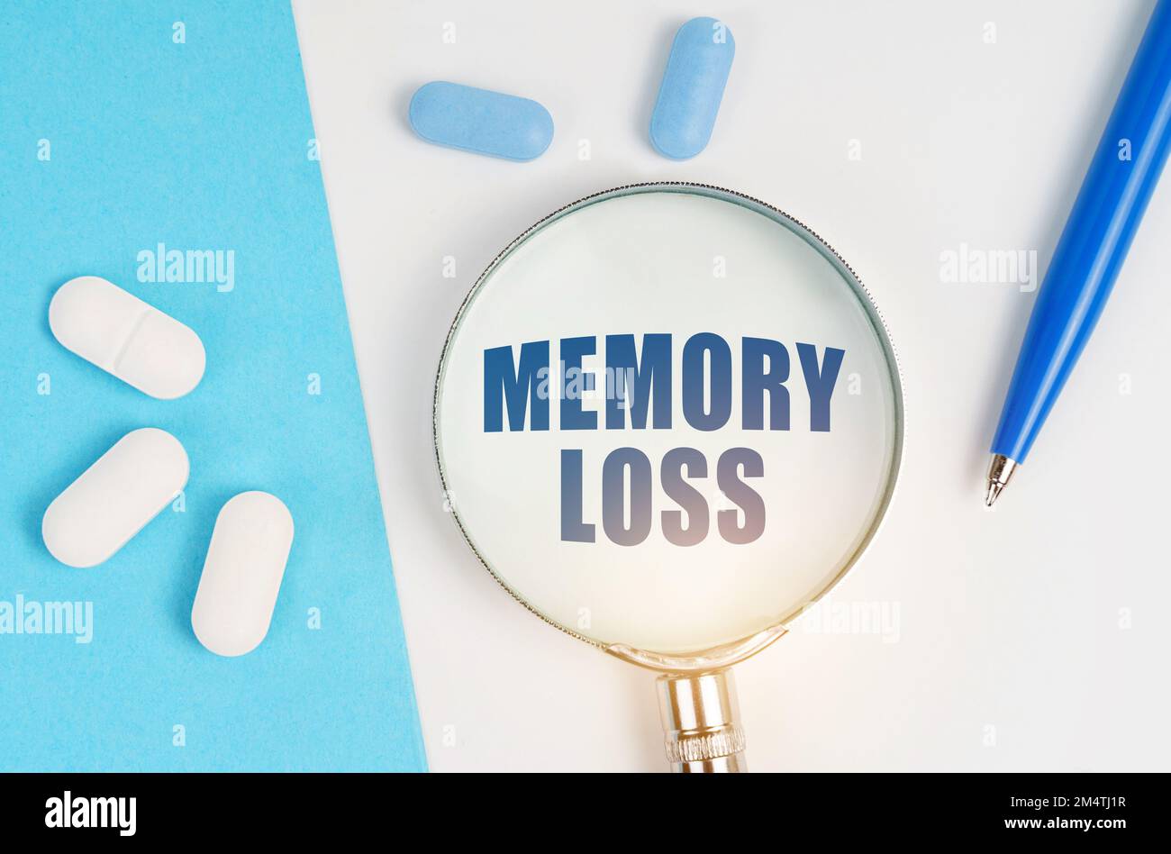 Medical concept. On a white and blue surface are pills, a pen and a ...