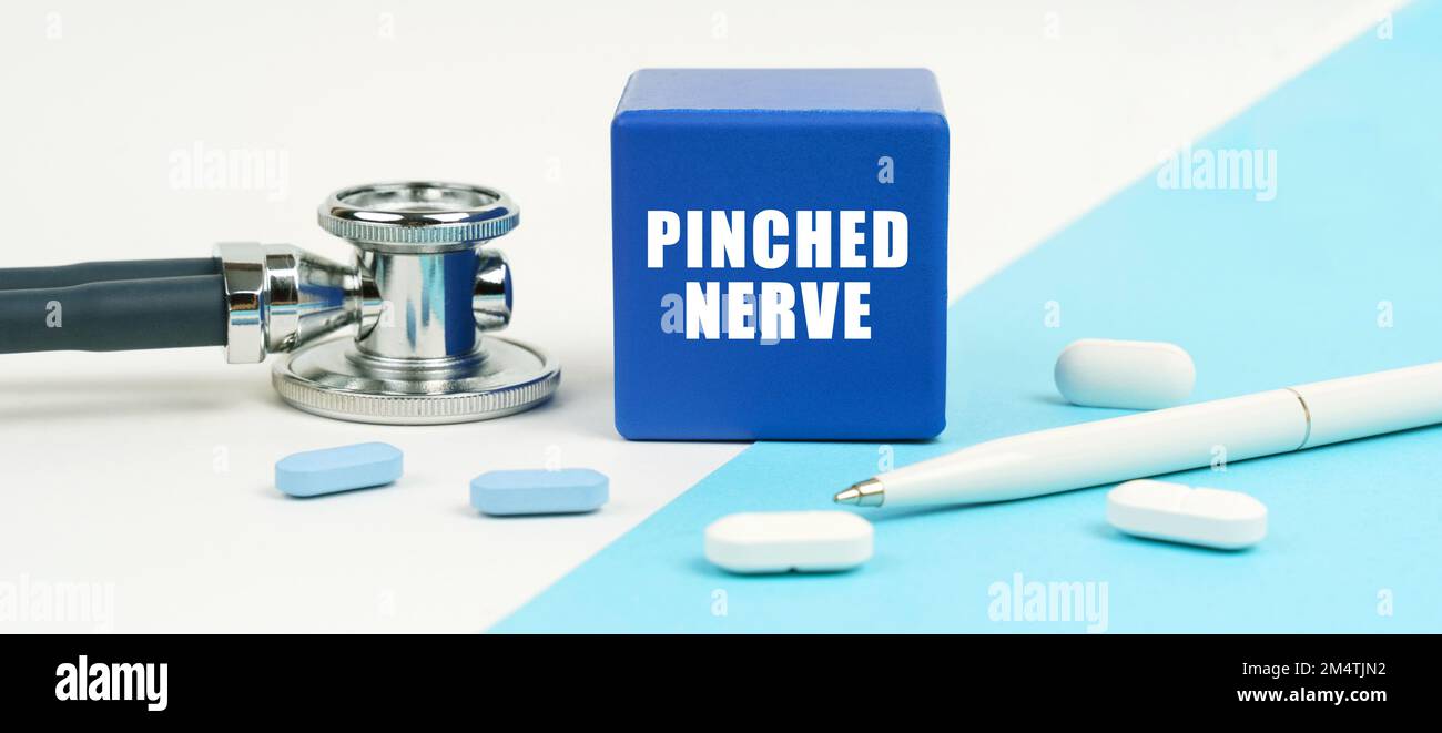 Medical concept. On a white and blue surface are pills, a stethoscope