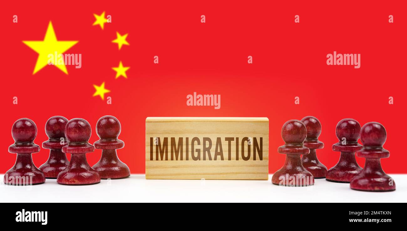 national concept. Against the background of the flag of China, pawns and a sign with the inscription - immigration Stock Photo