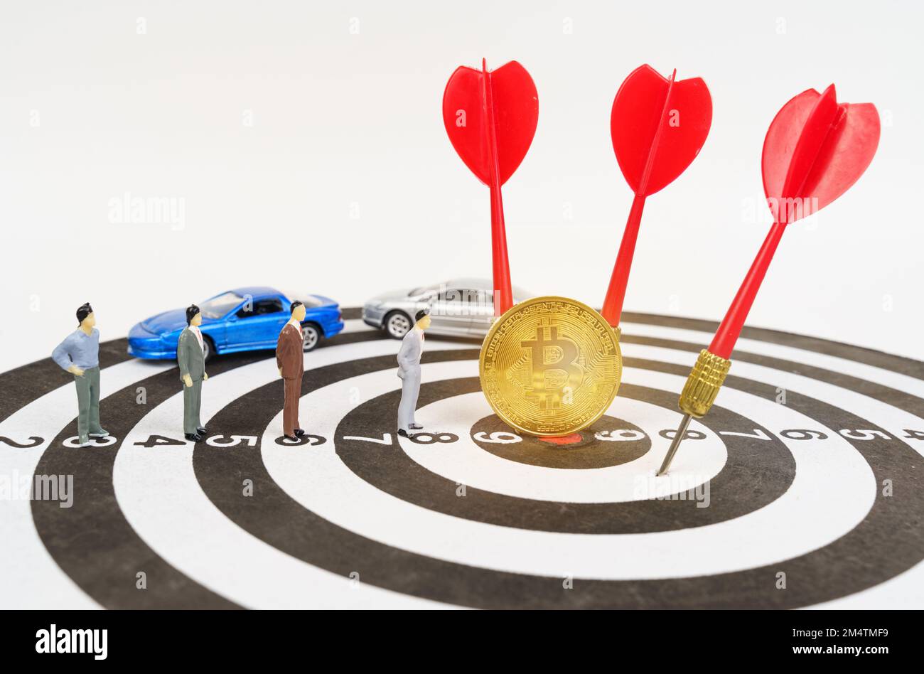 Cryptocurrency and business concept. On the target are miniature figures of  people, bitcoin, darts. Cars are in the background Stock Photo - Alamy