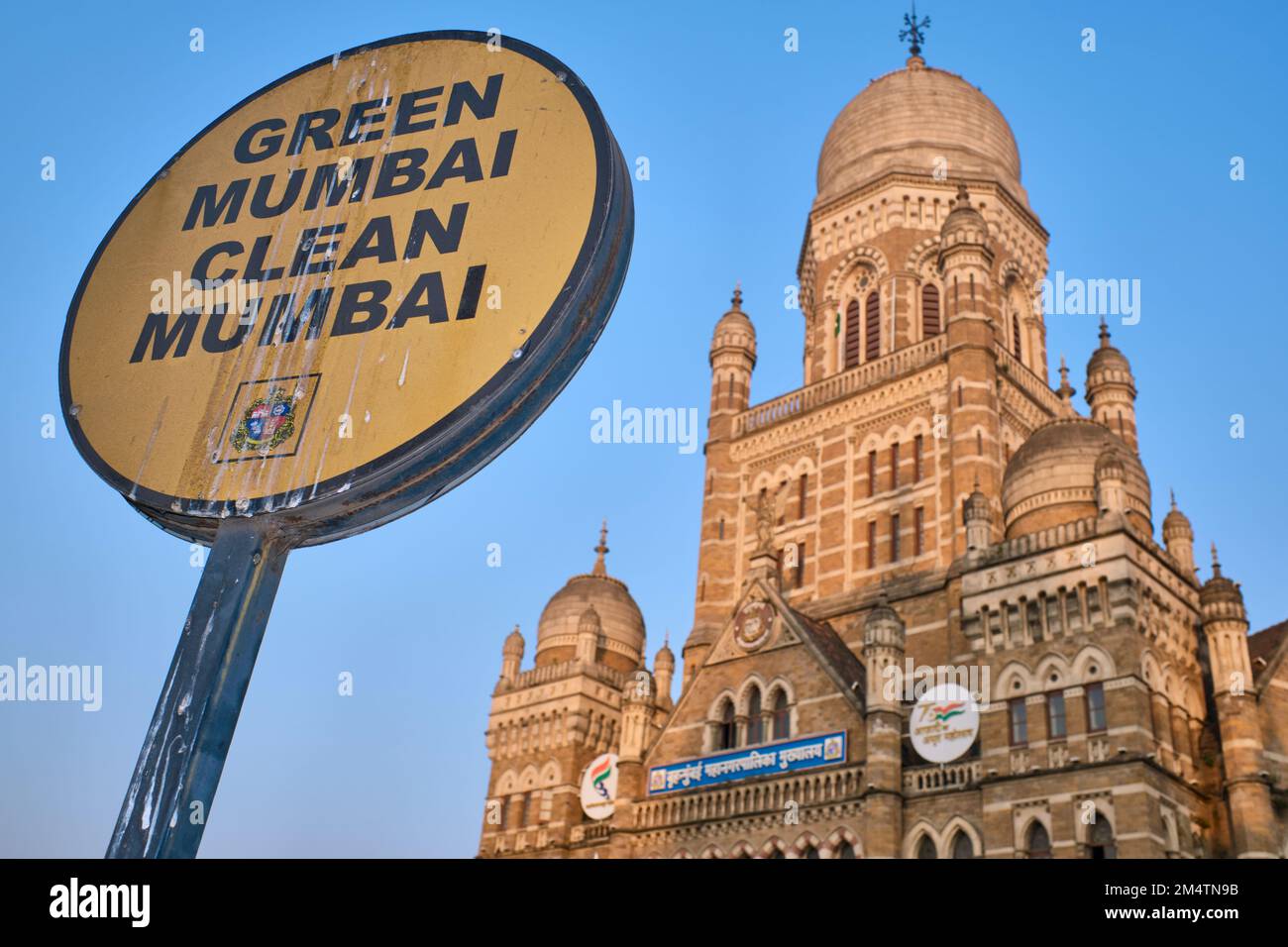 A sign covered in bird droppings in Mumbai, India, depicting the slogan