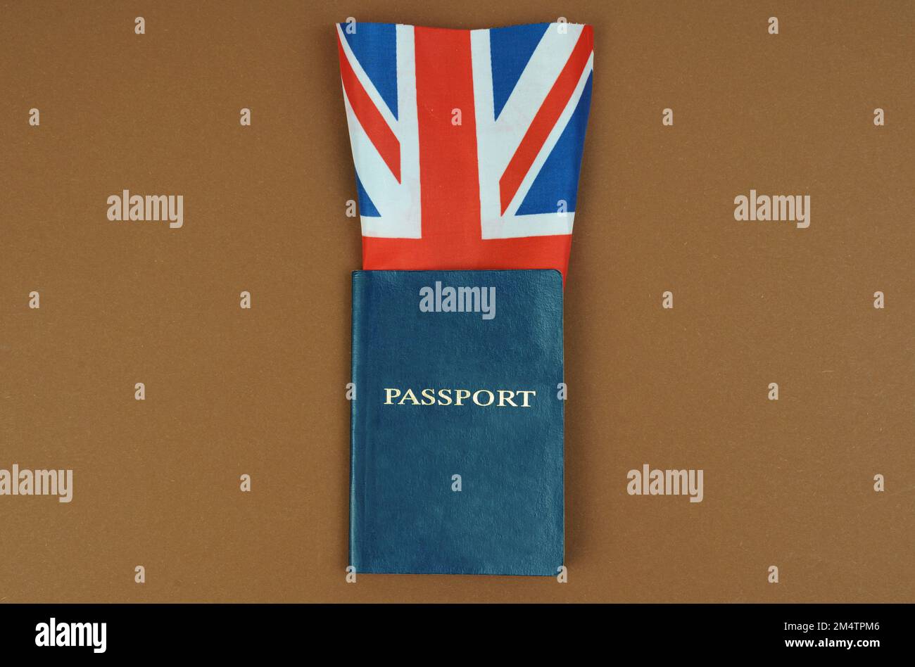 Migration concept. On a brown surface lies a passport inside which is the flag of Great Britain. Stock Photo