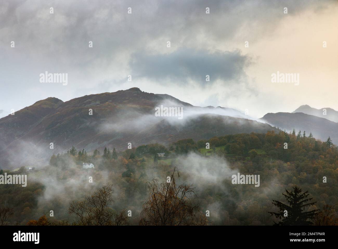 Mist swirling around Ligmoor Fell in the English Lake District. Stock Photo