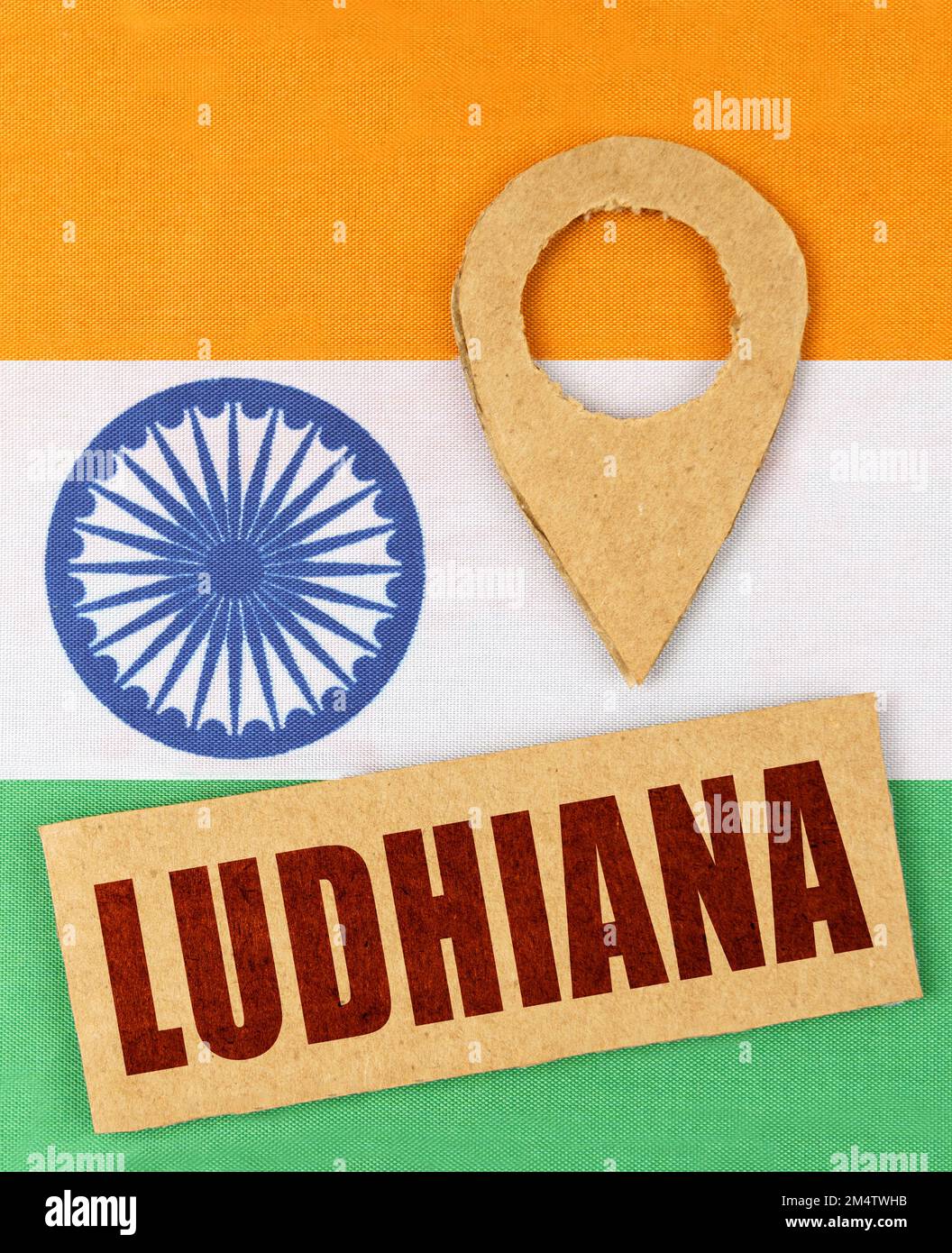 The concept of tourism, vacation and geolocation. On the Indian flag, a geolocation symbol and a sign with the inscription - Ludhiana Stock Photo
