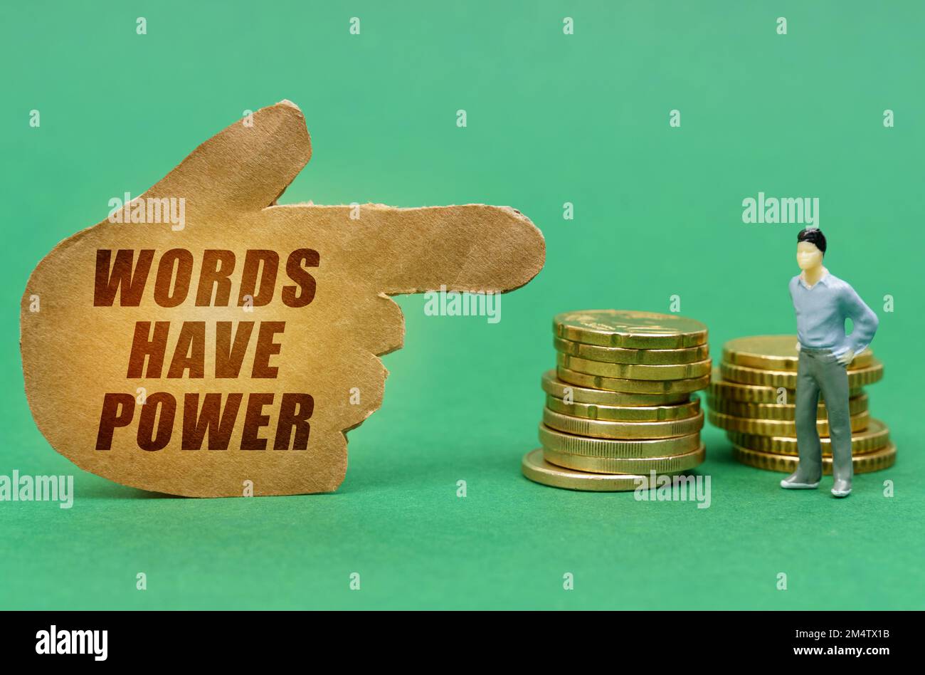 Business and economy concept. On the green surface of the coin and a figure of a man, they are indicated by a sign - a hand with the inscription - Wor Stock Photo