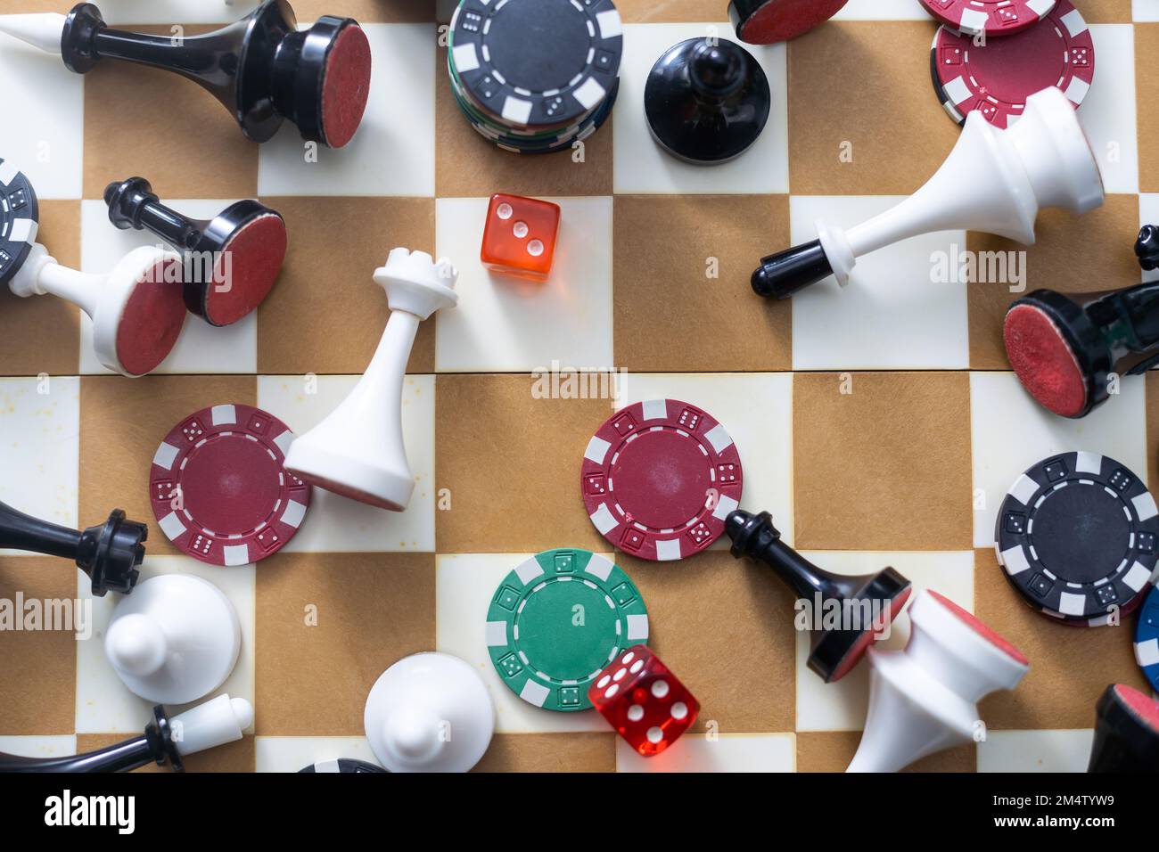 Wooden checkers, chess pieces, playing cards, board games on a light