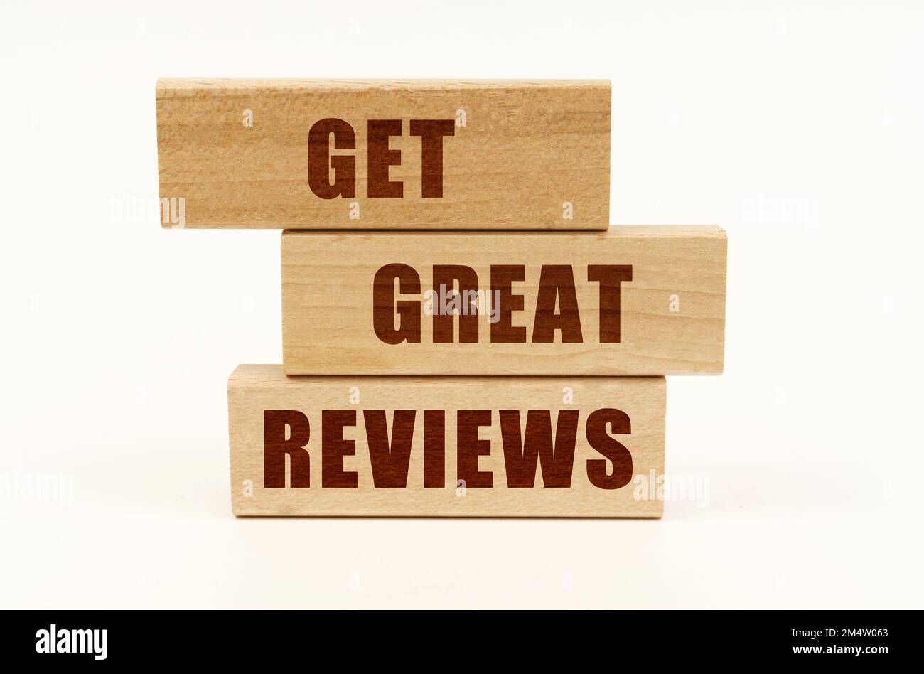 Business concept. On a white surface are wooden blocks with the ...