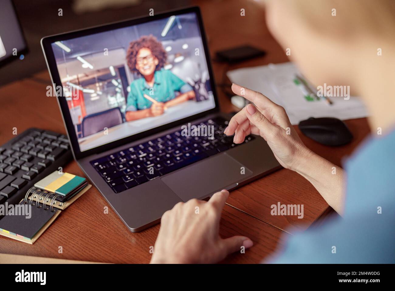 Unrecognizable woman talking with client via online video call from home office Stock Photo