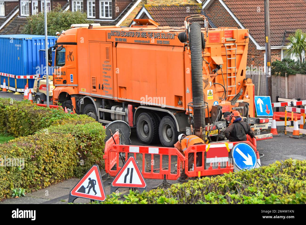 Workmen use suction excavator by German business RSP on hgv Mercedes lorry truck quickly creating single earth pit to expose underground gas main UK Stock Photo