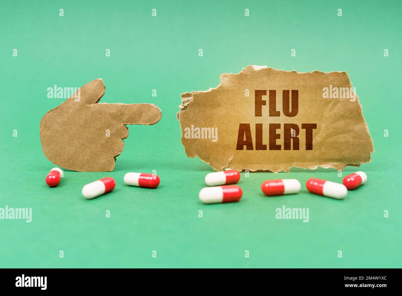 Medical concept. On the green surface of the tablet and a hand pointing to a sign with the inscription - Flu alert Stock Photo