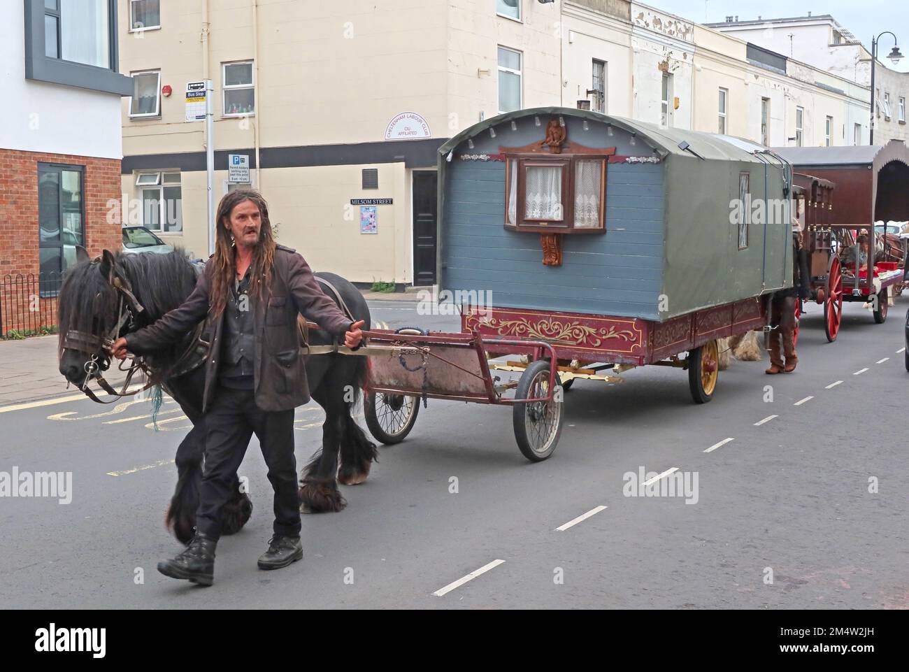 Traditional Gypsy caravan travelling through the High St, Cheltenham, Gloucestershire, England, UK, GL50 3JF Stock Photo