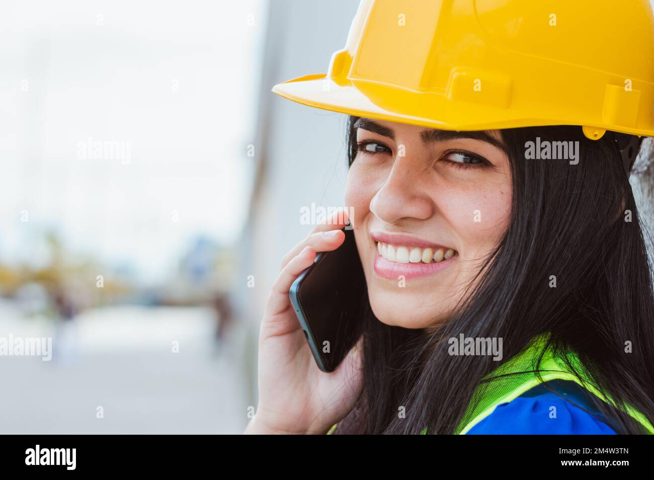 closeup of young latina caucasian venezuelan engineer woman with yellow ...