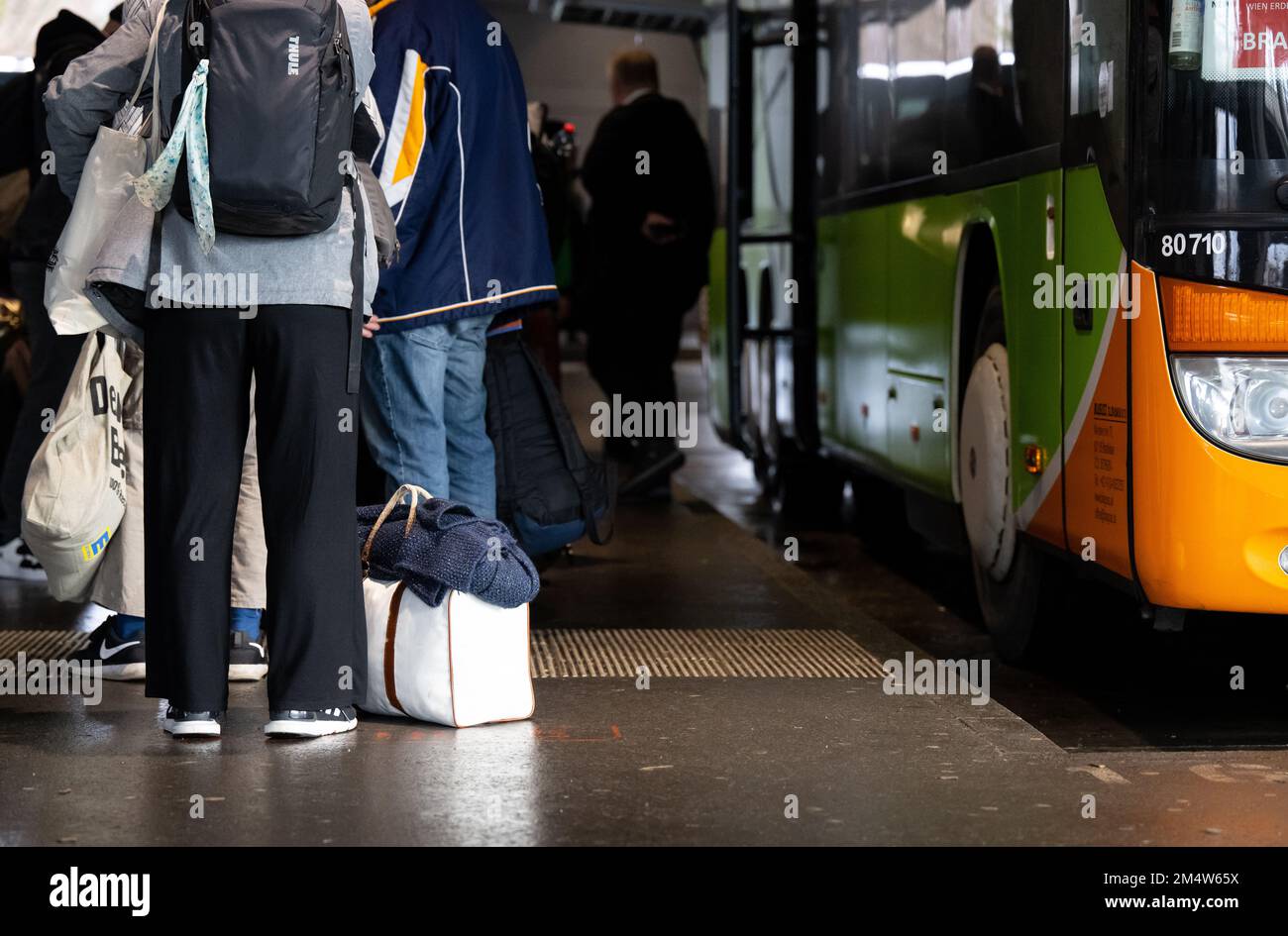 Munich, Germany. 23rd Dec, 2022. Travelers wait at the central bus station in Munich. Many people are rushing home for Christmas, and some are traveling further afield: Germany's roads are at risk of traffic jams over the Christmas period due to the heavy travel traffic around the festive season. In Bavaria, the ADAC expects the A3 Frankfurt-Nuremberg-Passau, the A8 Stuttgart-Munich-Salzburg or the A9 Munich-Nuremberg-Berlin, among others, to reach their capacity limits. Credit: Sven Hoppe/dpa/Alamy Live News Stock Photo