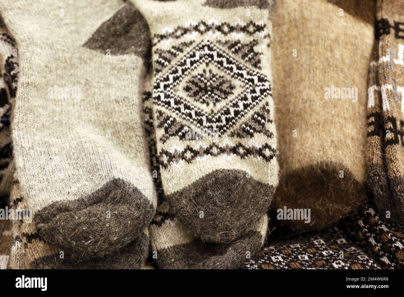 Warm knitted socks with pattern in a store. Outfit and gifts for winter holidays Stock Photo