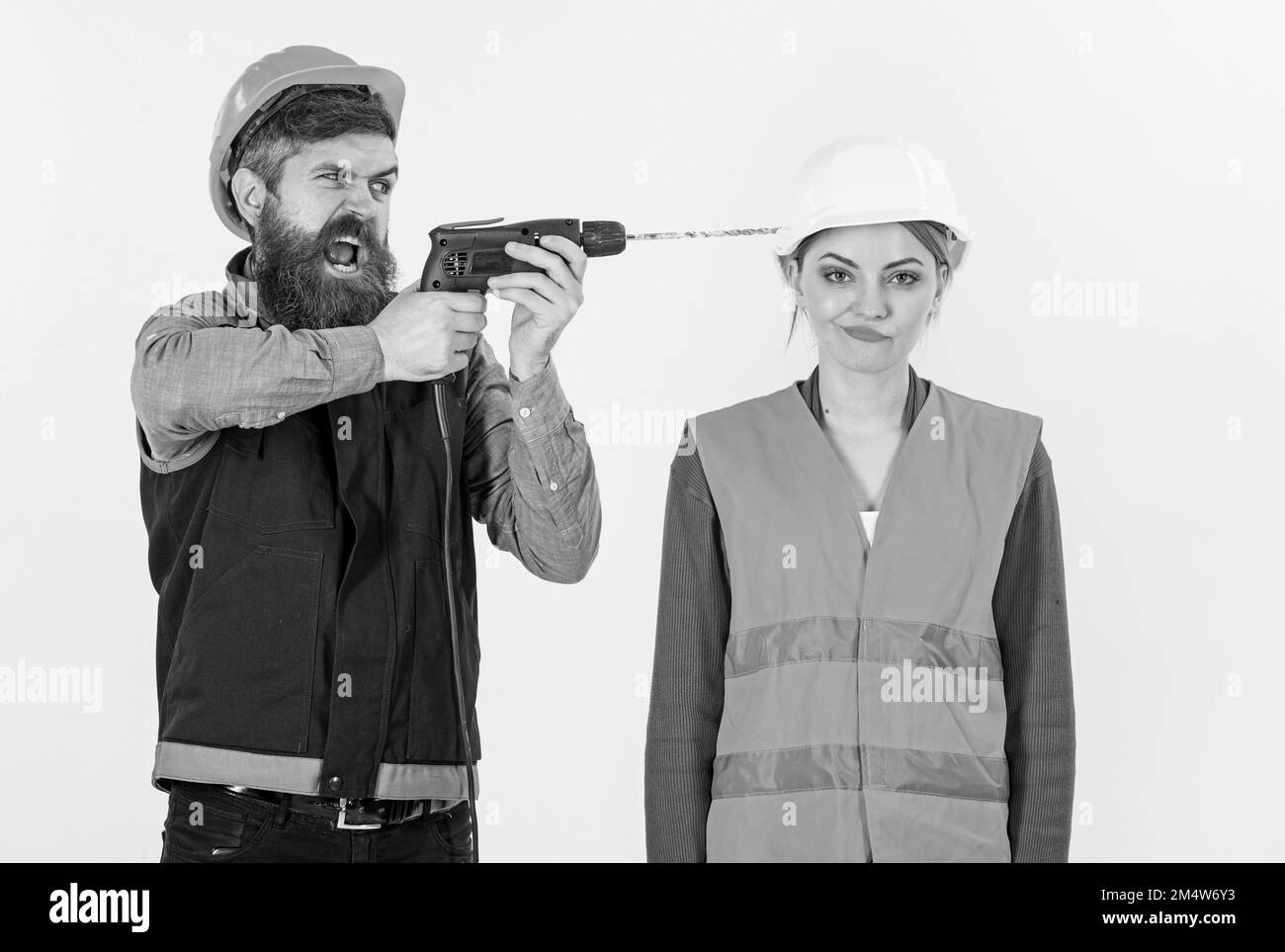 Annoying repair concept. Man with drill drills head of woman, Stock Photo