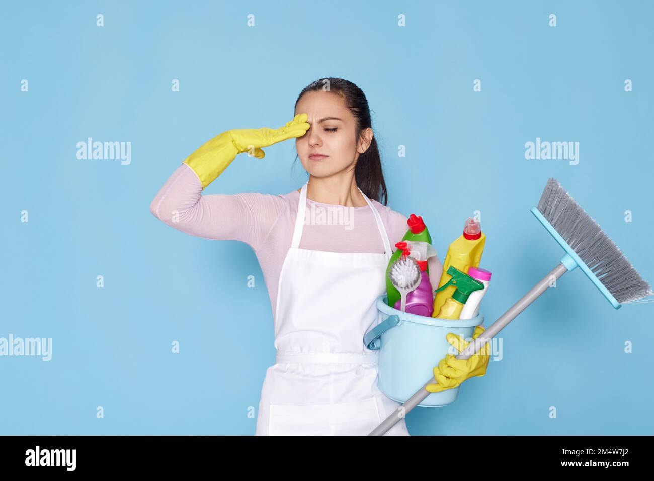 woman in gloves holding bucket with cleaning supplies and broom Stock ...
