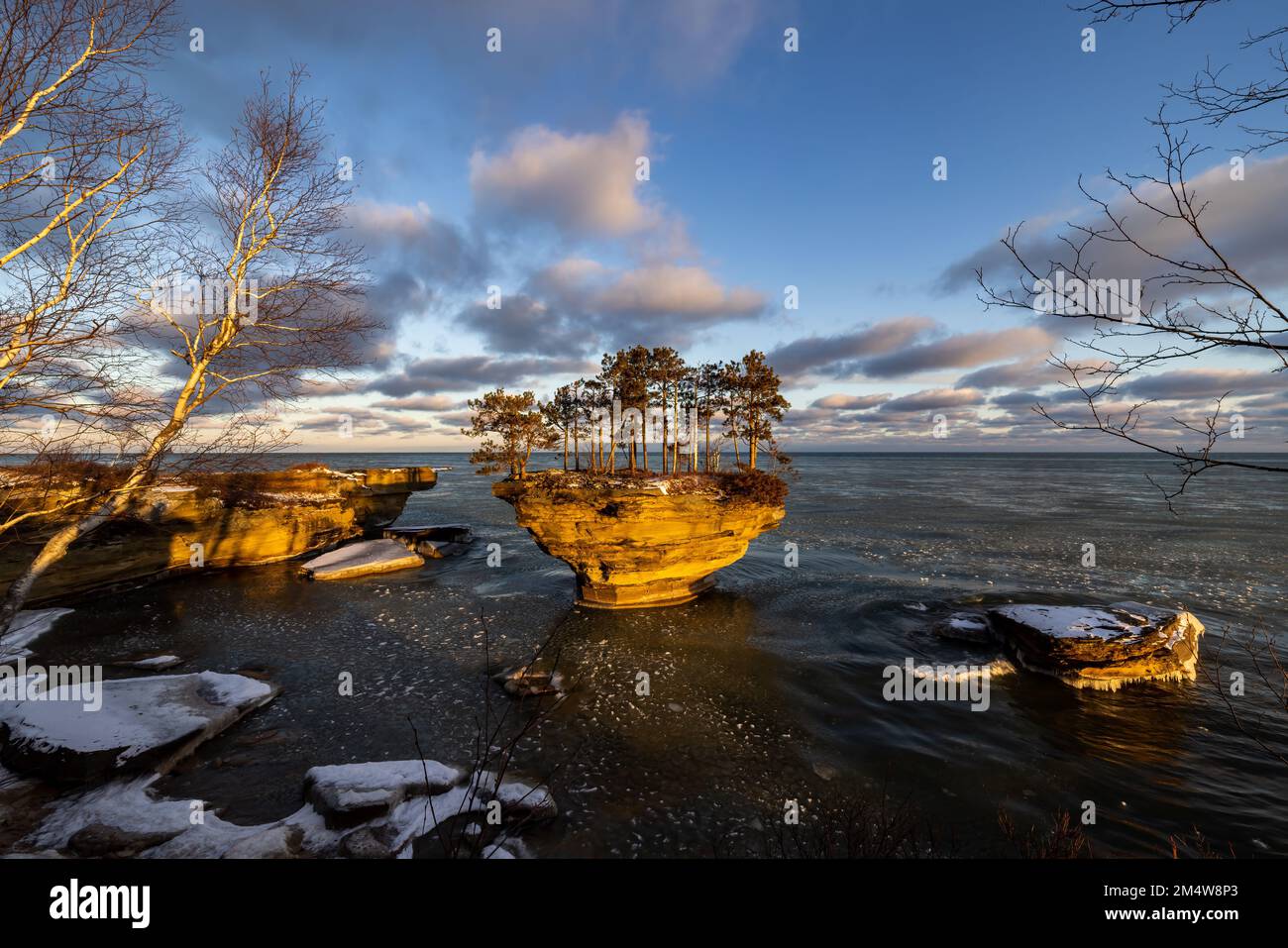 Turnip Rock at the tip of Michigan's thumb near Port Austin is shown in early winter. Pancake ice floats on Lake Huron's surface as winter arrives Stock Photo