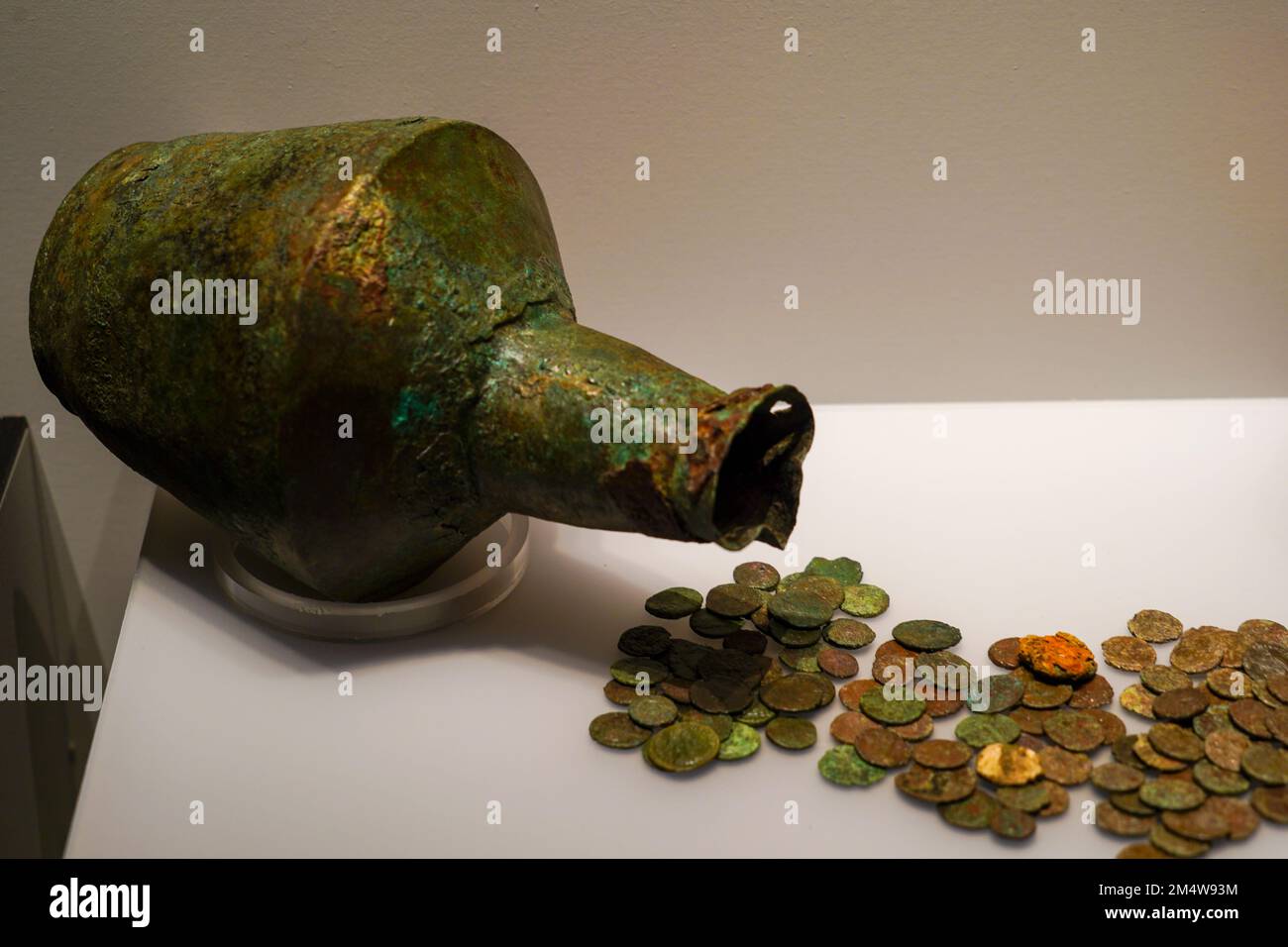 Ancient jug and coins Archaeological artifact on display at the Archaeological Museum, Chania, Crete Stock Photo
