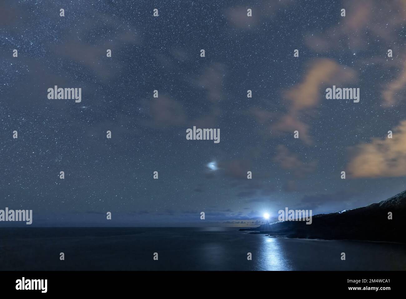 Lighthouse lightning under the dark night with stars Stock Photo