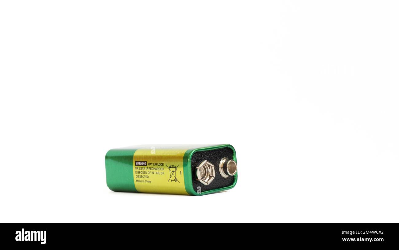 9 volt alkaline battery isolated on white background. 9 V (PP3) alkaline battery. Plus and minus poles resembling a pair of eyes. Copy space. Stock Photo