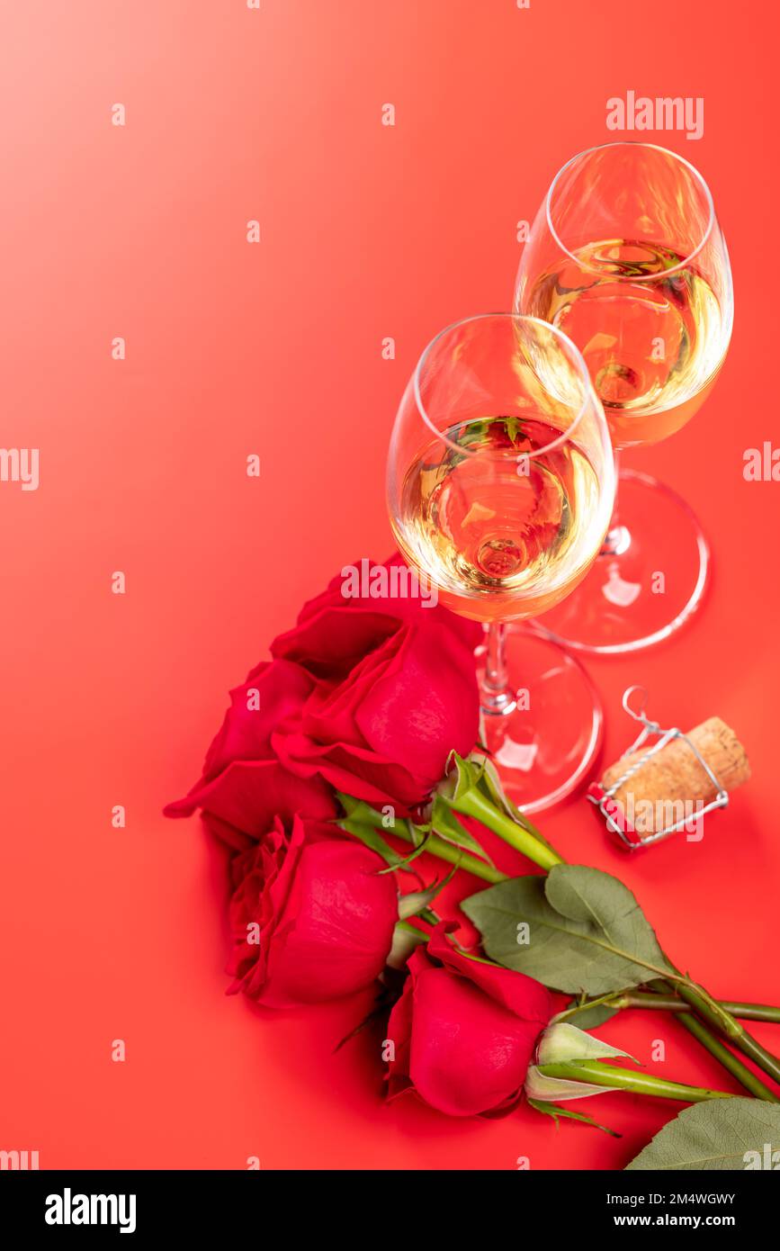 Valentines day card with champagne and rose flowers. On red background ...