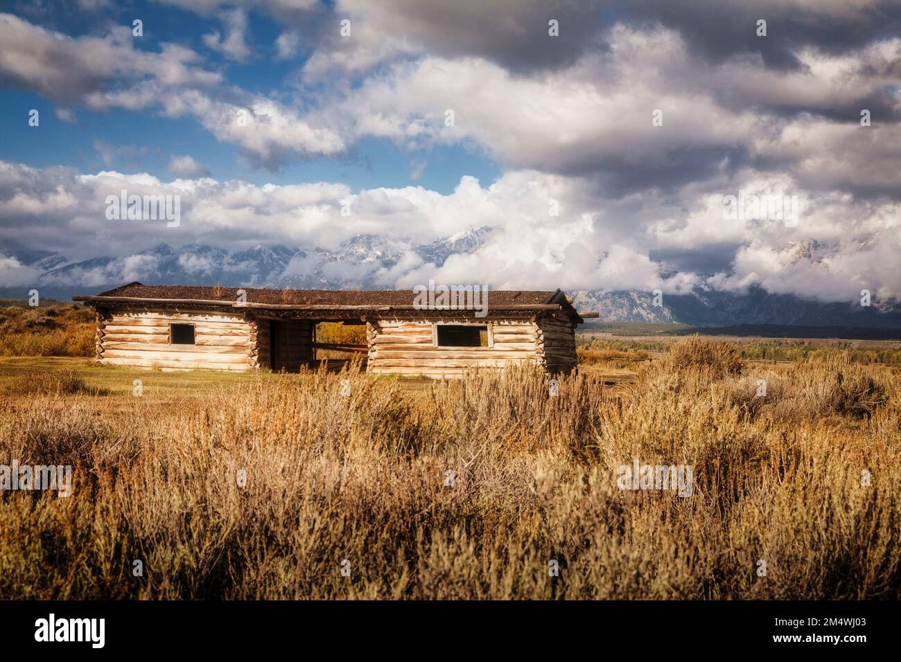 Cunningham Cabin with the mountains of Grand Teton National Park in the distance. Wyoming. Stock Photo