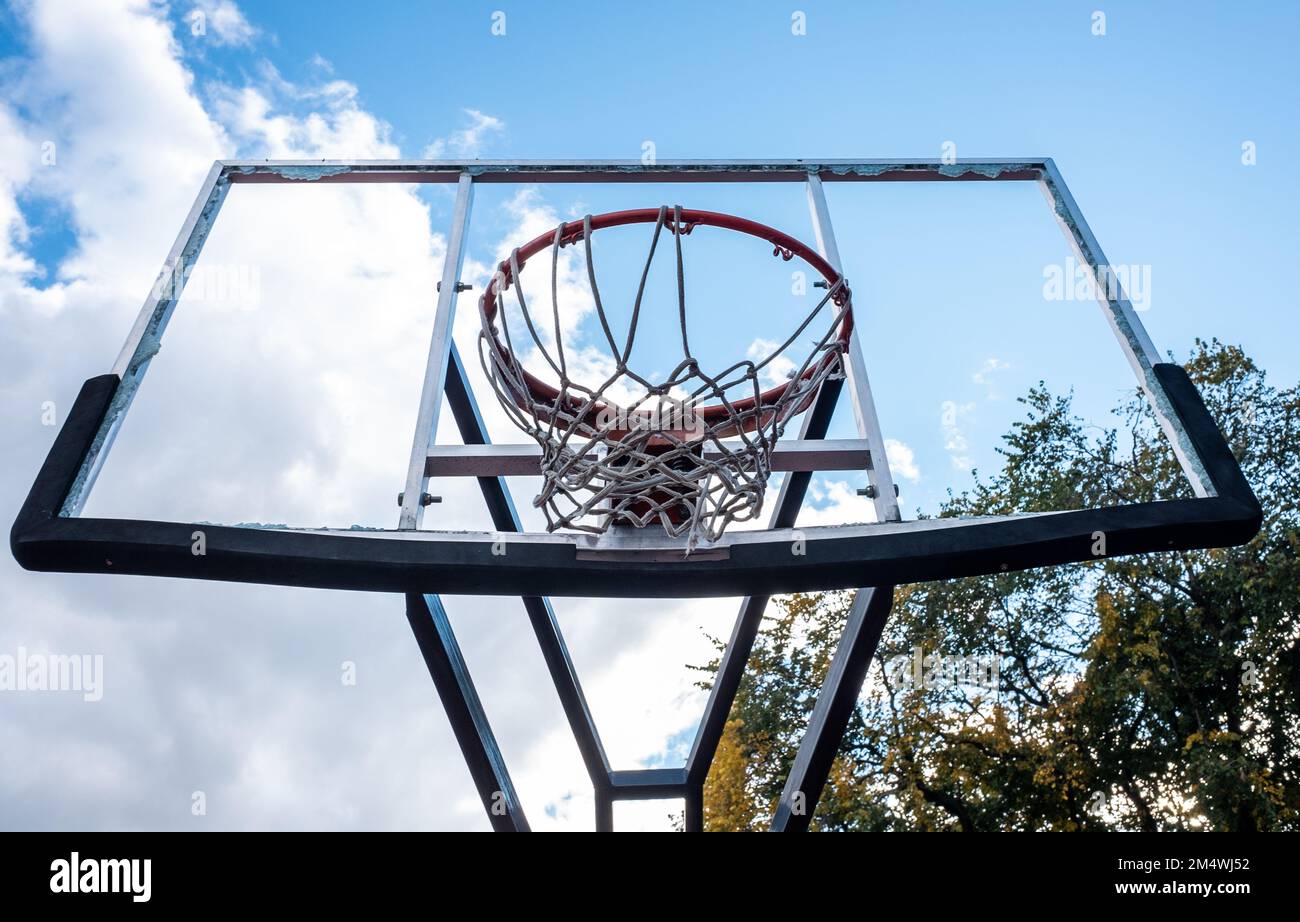 Broken glass backboard and broken hoop on the basketball court Stock