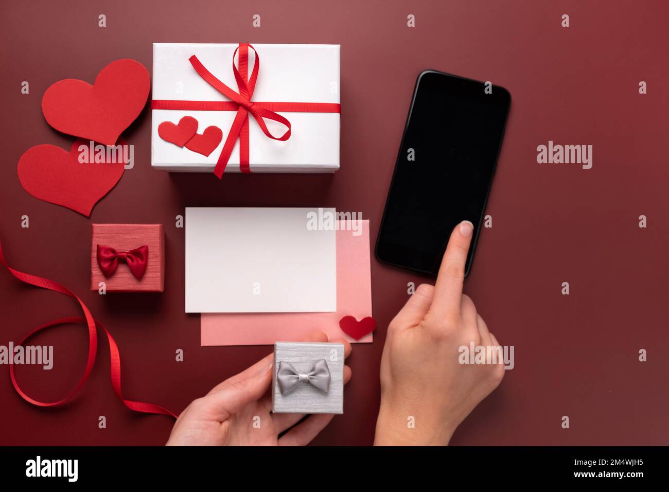 St. Valentine's Day online shopping gifts in boxes. Search in smartphone  for gifts. Copy space for love message. White card with envelope, mock up  Stock Photo - Alamy