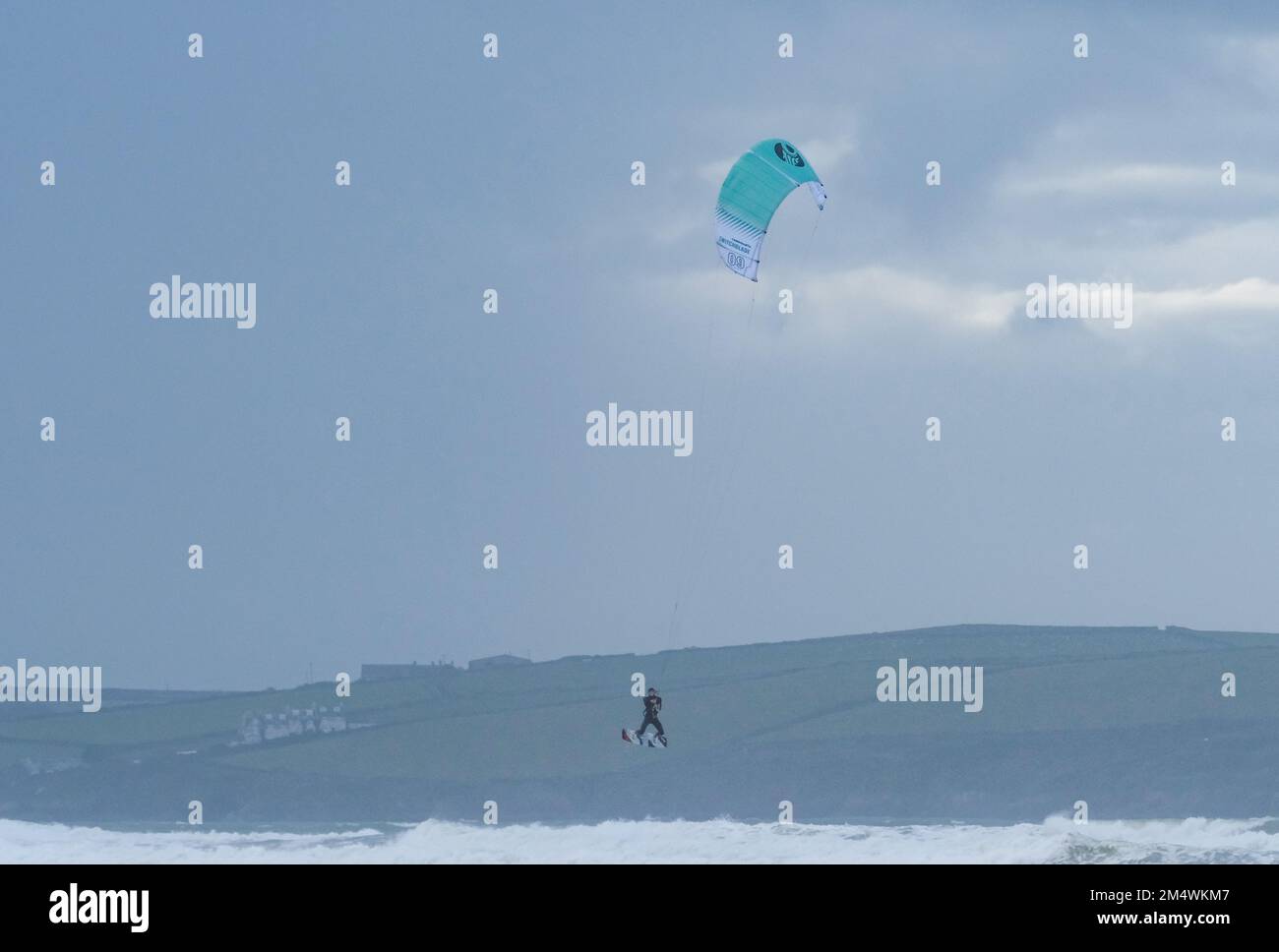 Polzeath, Cornwall, UK.23rd December 2022. UK Weather. It was blustery but fine on the beach at Polzeath this afternoon. With kite surfers and dog walkers enjoying the conditions. Credit SImon Maycock / Alamy Live News. Stock Photo