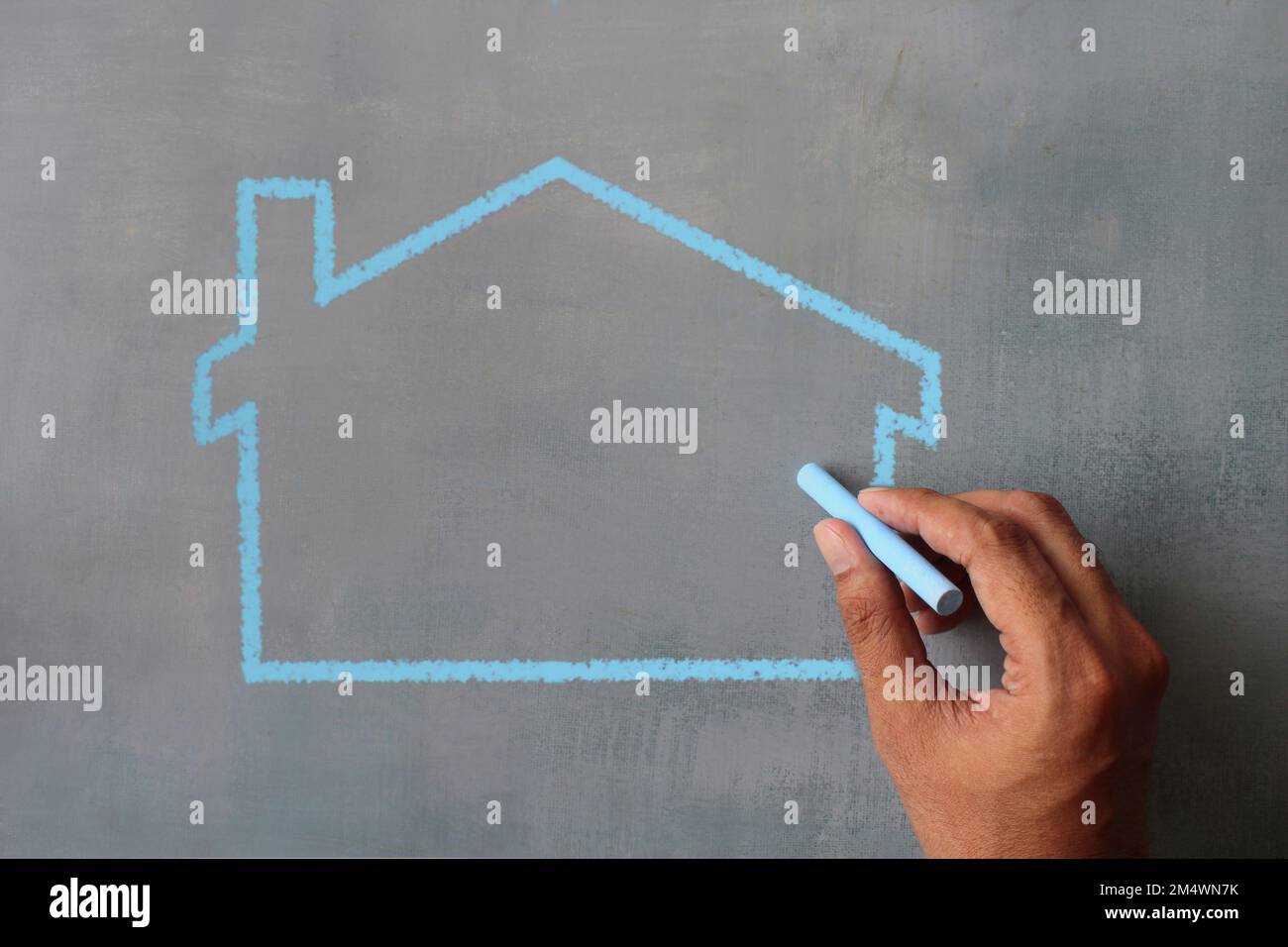 Top view image of hand drawing house icon on chalkboard. Copy space for text Stock Photo