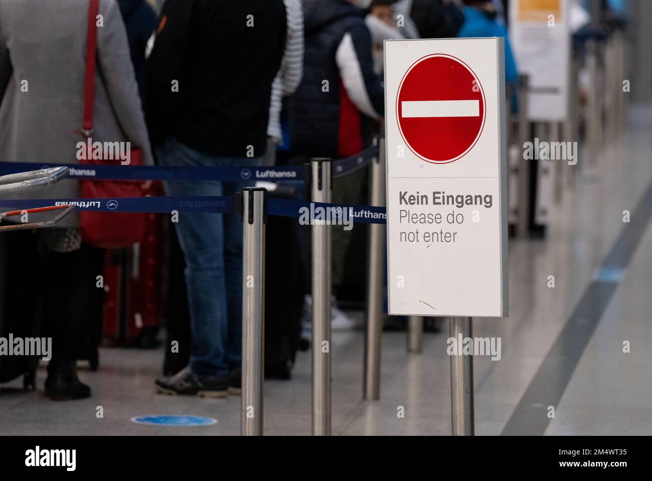 Munich, Germany. 23rd Dec, 2022. Passengers stand with their luggage at check-in counters at Munich Airport. Credit: Sven Hoppe/dpa/Alamy Live News Stock Photo