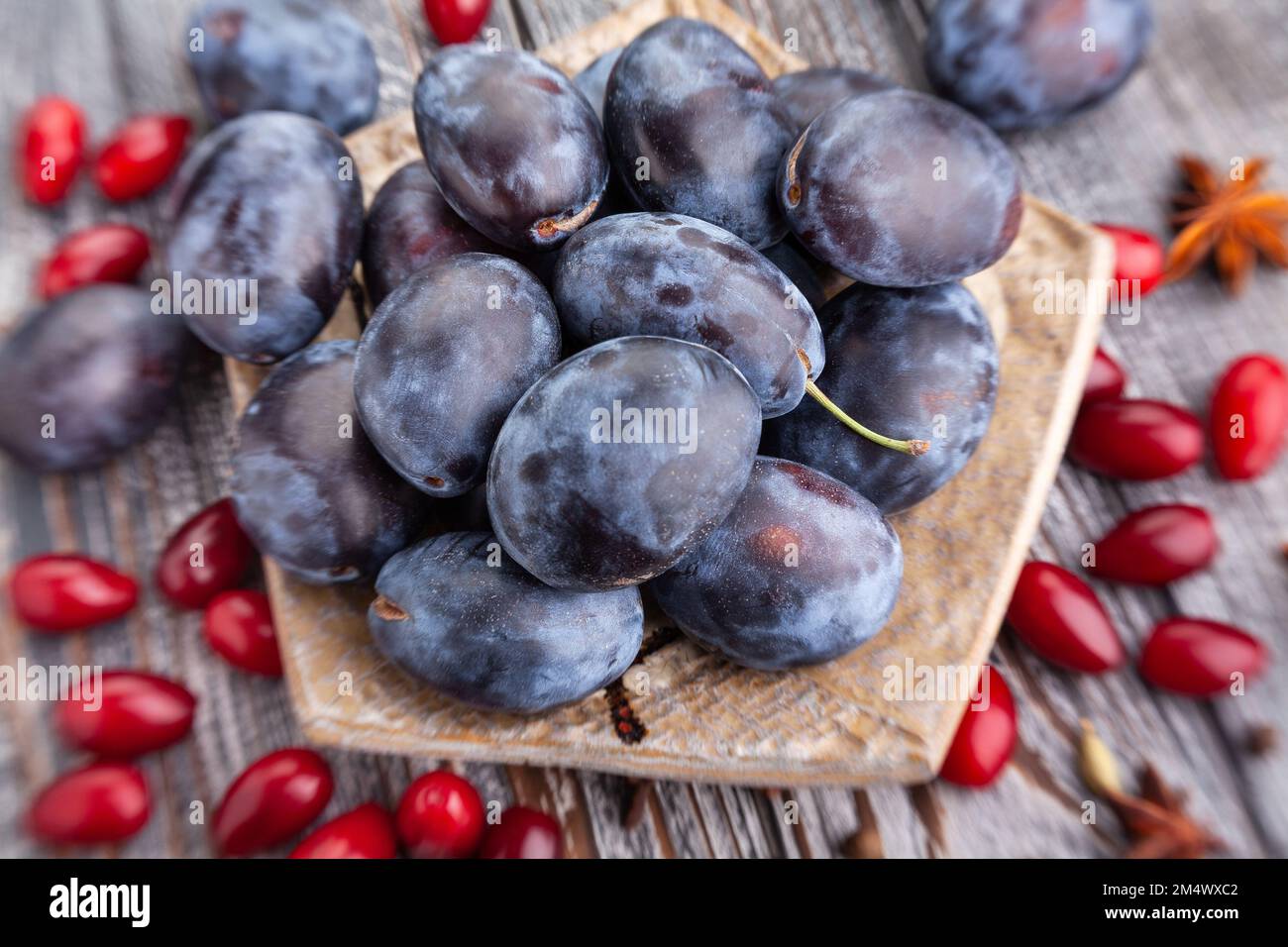 prune plums on wood background Stock Photo