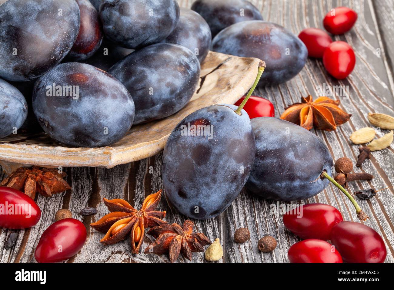 prune plums on wood background Stock Photo