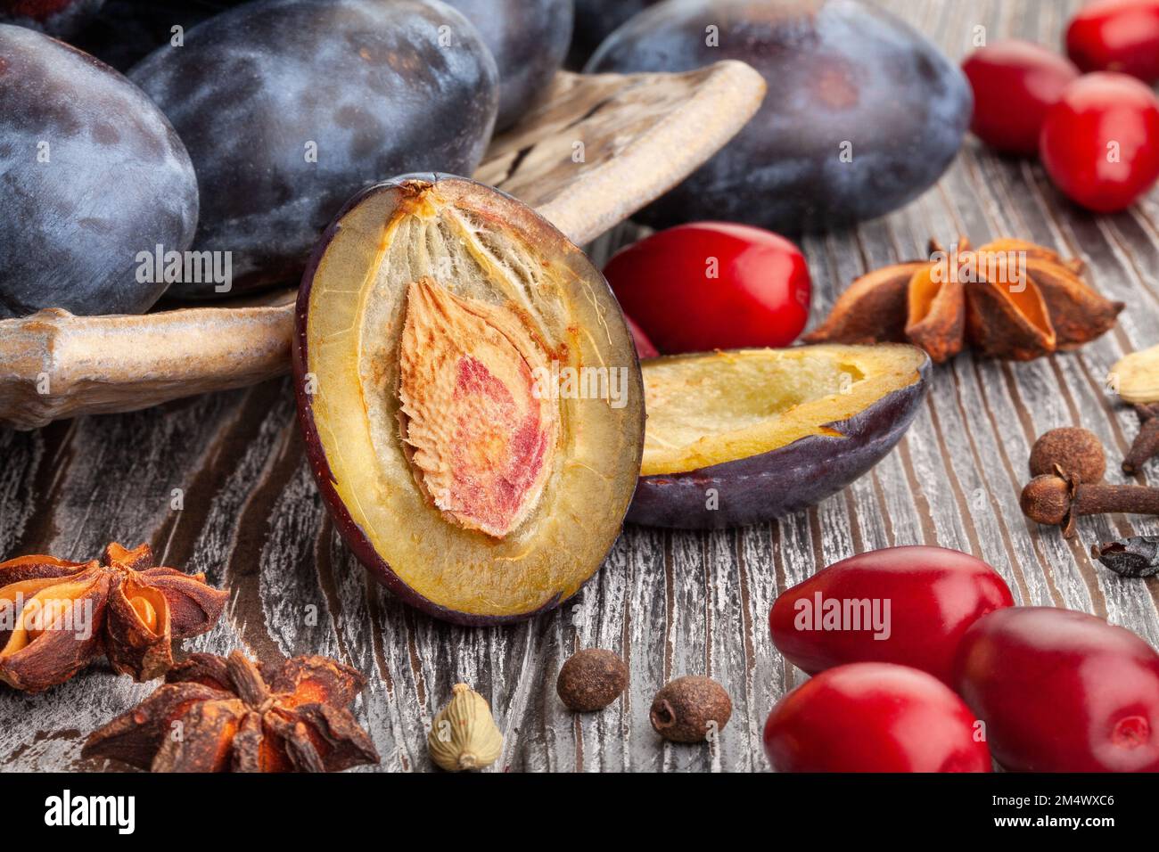 sliced prune plums on wood background Stock Photo