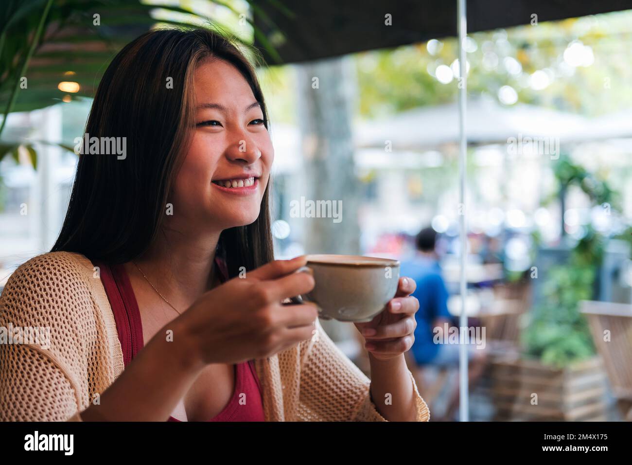asian woman drinking coffee in a coffee shop Stock Photo