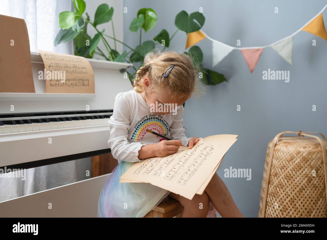 Girl sitting on stool writing hi-res stock photography and images - Alamy