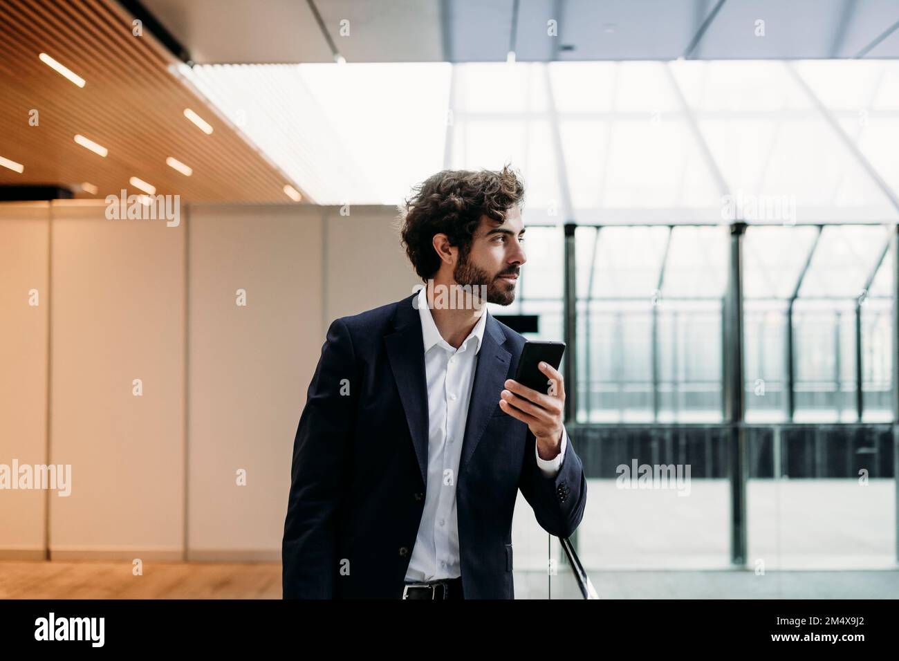Young businessman holding smart phone Stock Photo