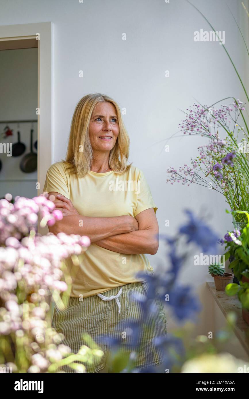 Mature woman home standing smiling hi-res stock photography and images ...