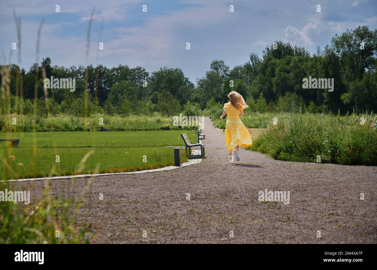 Woman running rear view park dress hi-res stock photography and images ...